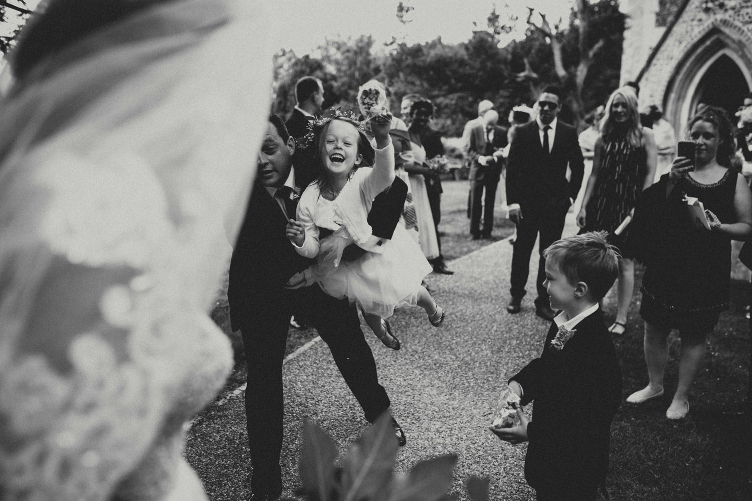 flower girl throwing confettis after cambridge wedding ceremony