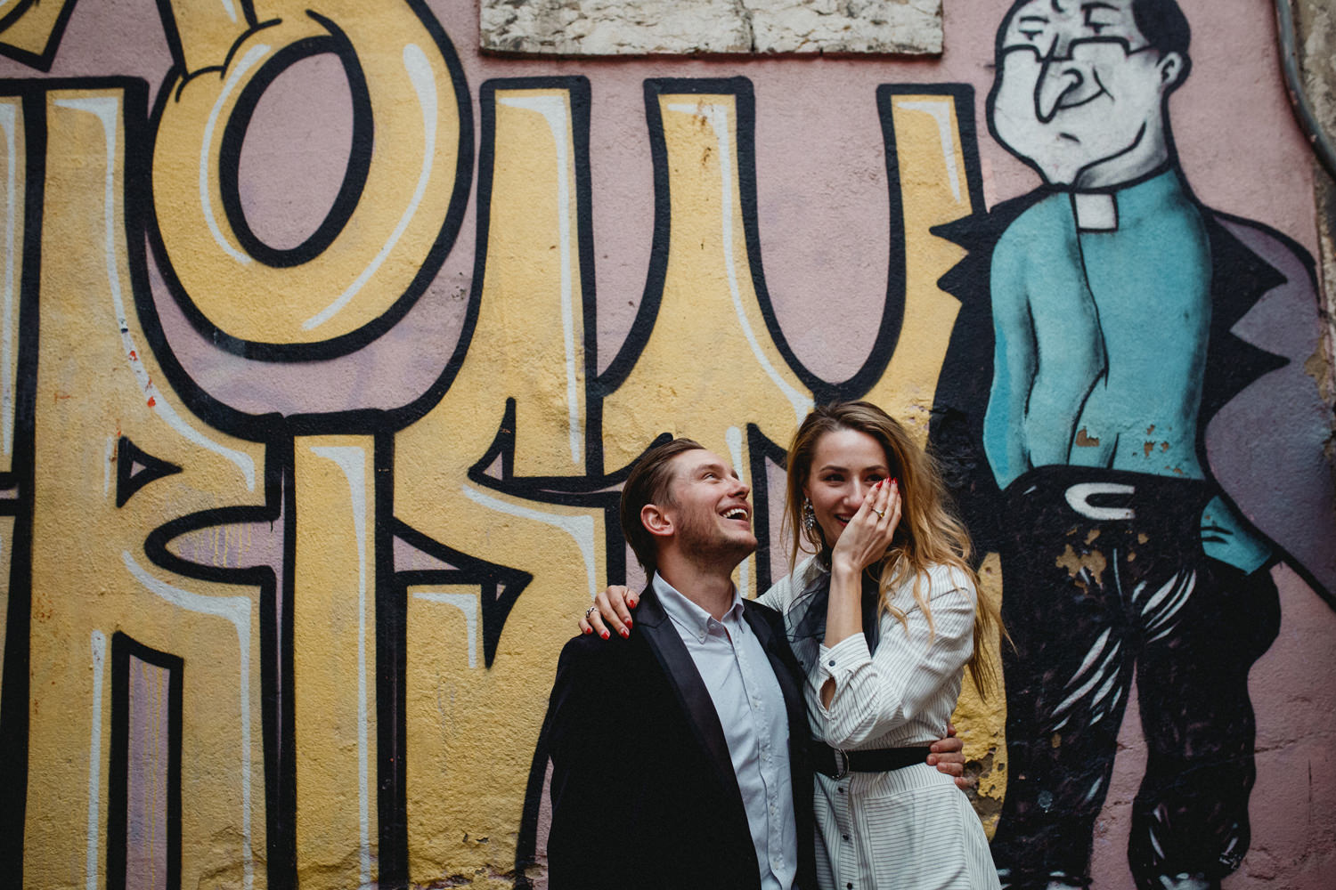 bride still emotional after getting engaged in lisbon portugal in front of a graffiti wall