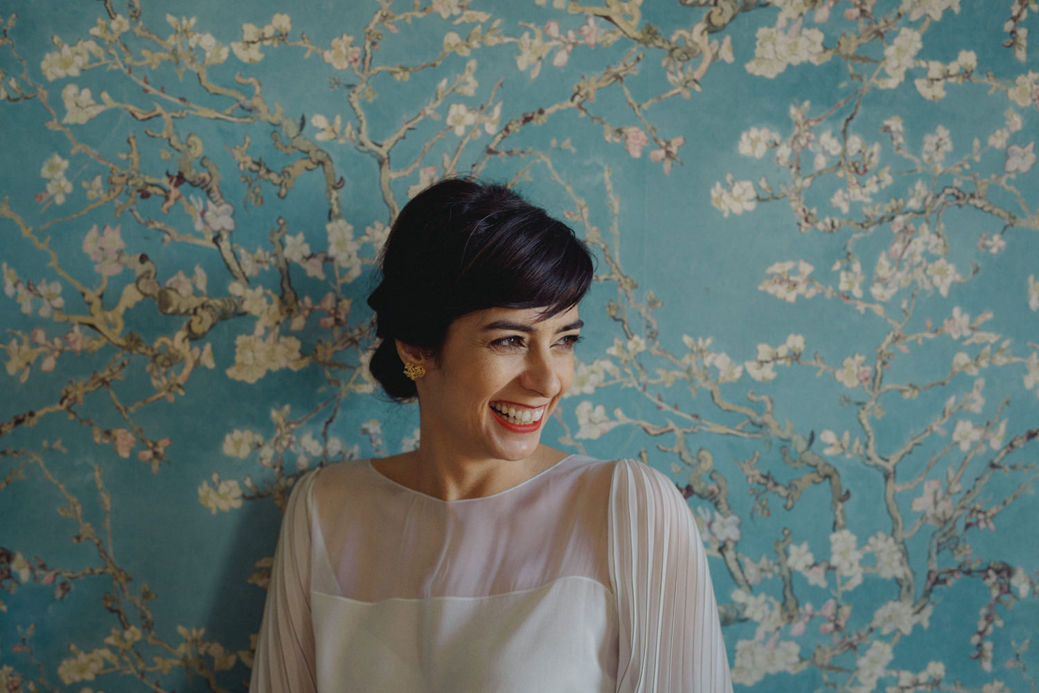smiling bride in front of stylish vintage wall on lisbon wedding
