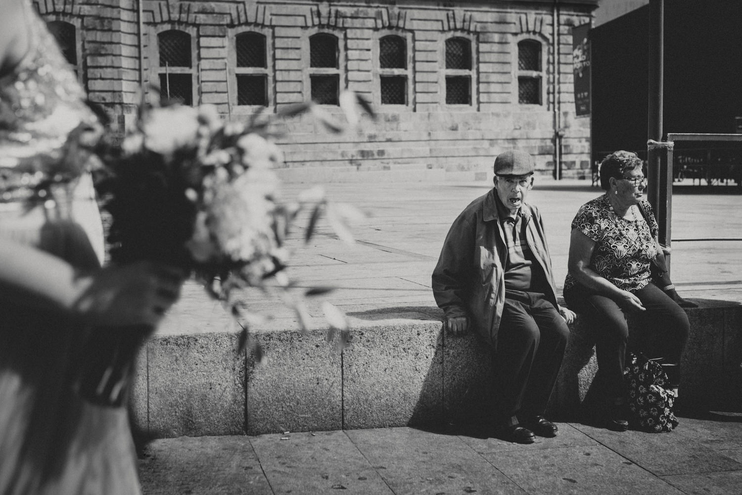 elderly man fascinated by gorgeous bride walkin on the streets of porto for her wedding