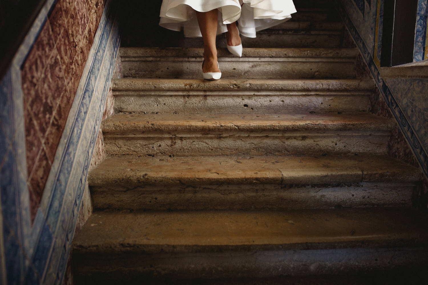 lisbon bride walking down the old tile staircase lisbon wedding photographers