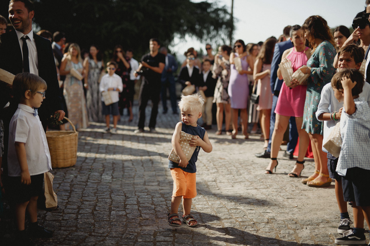 kids at a portugal wedding before tossing the petals