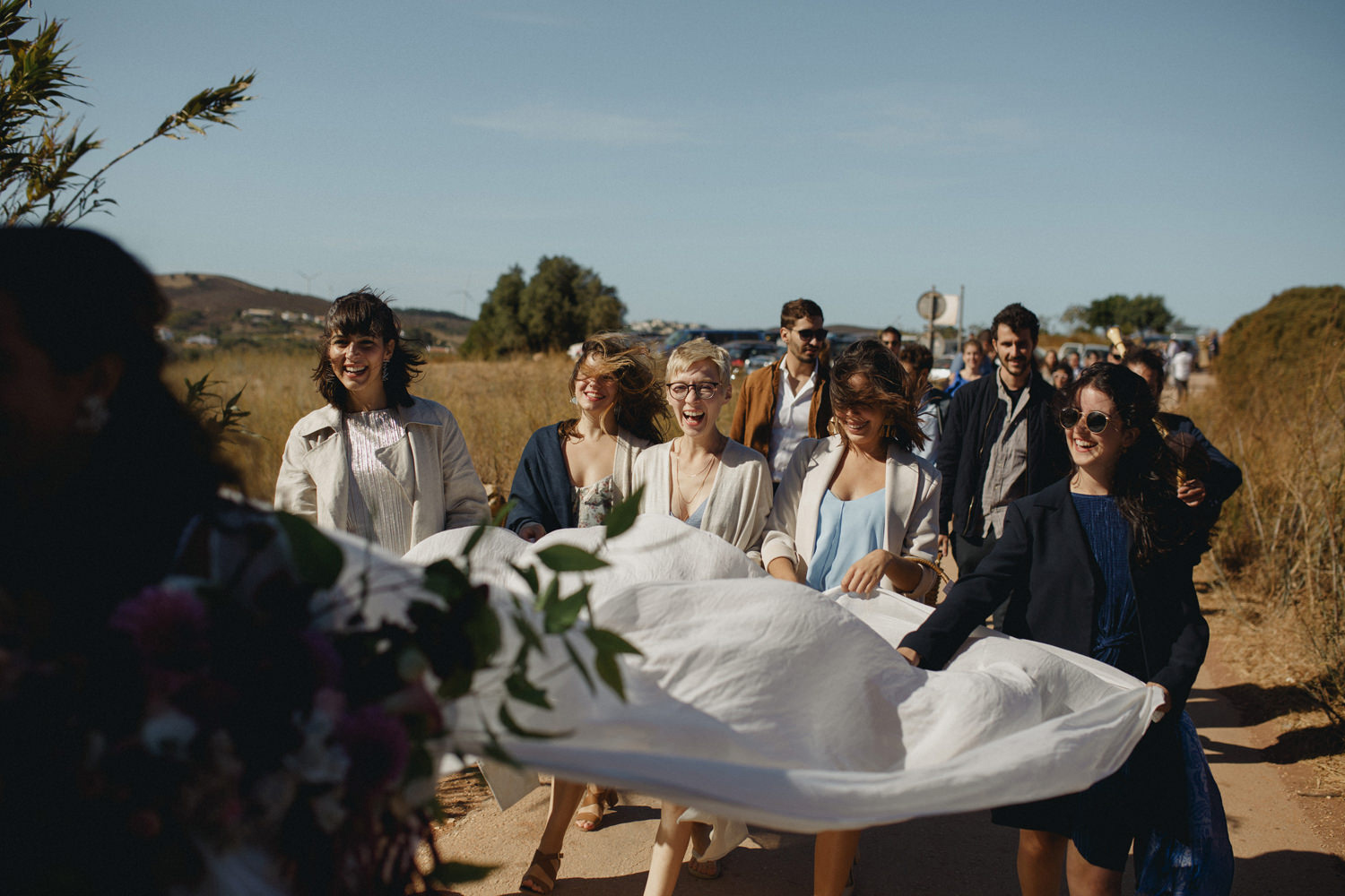 bridesmaids following the bride to a beach wedding ceremony in Algarve Portugal