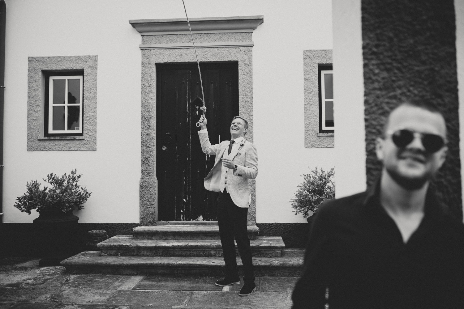 groom rings the bell before wedding ceremony portugal