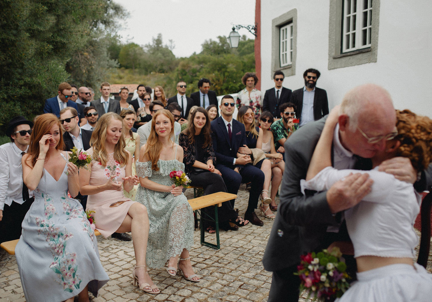 dad hugging bride after portugal wedding ceremony